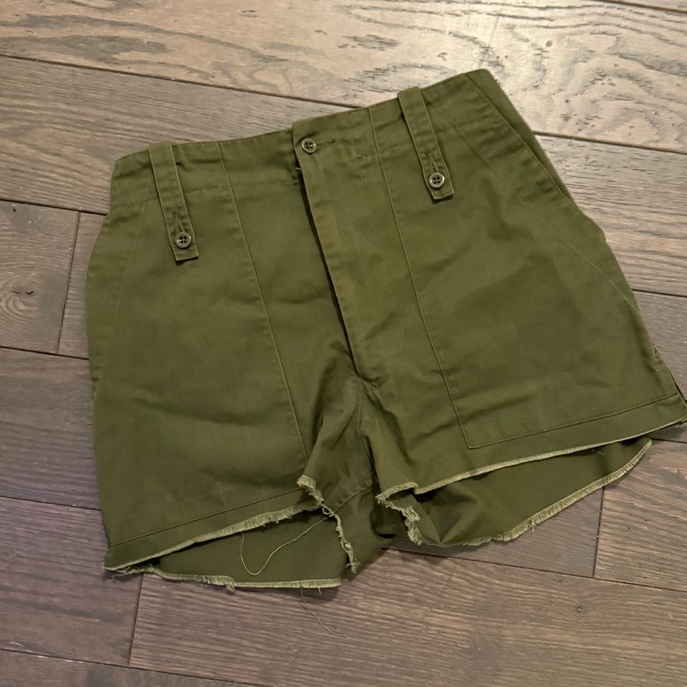 Army green shorts with side zippers and adjustable waist straps for tightening